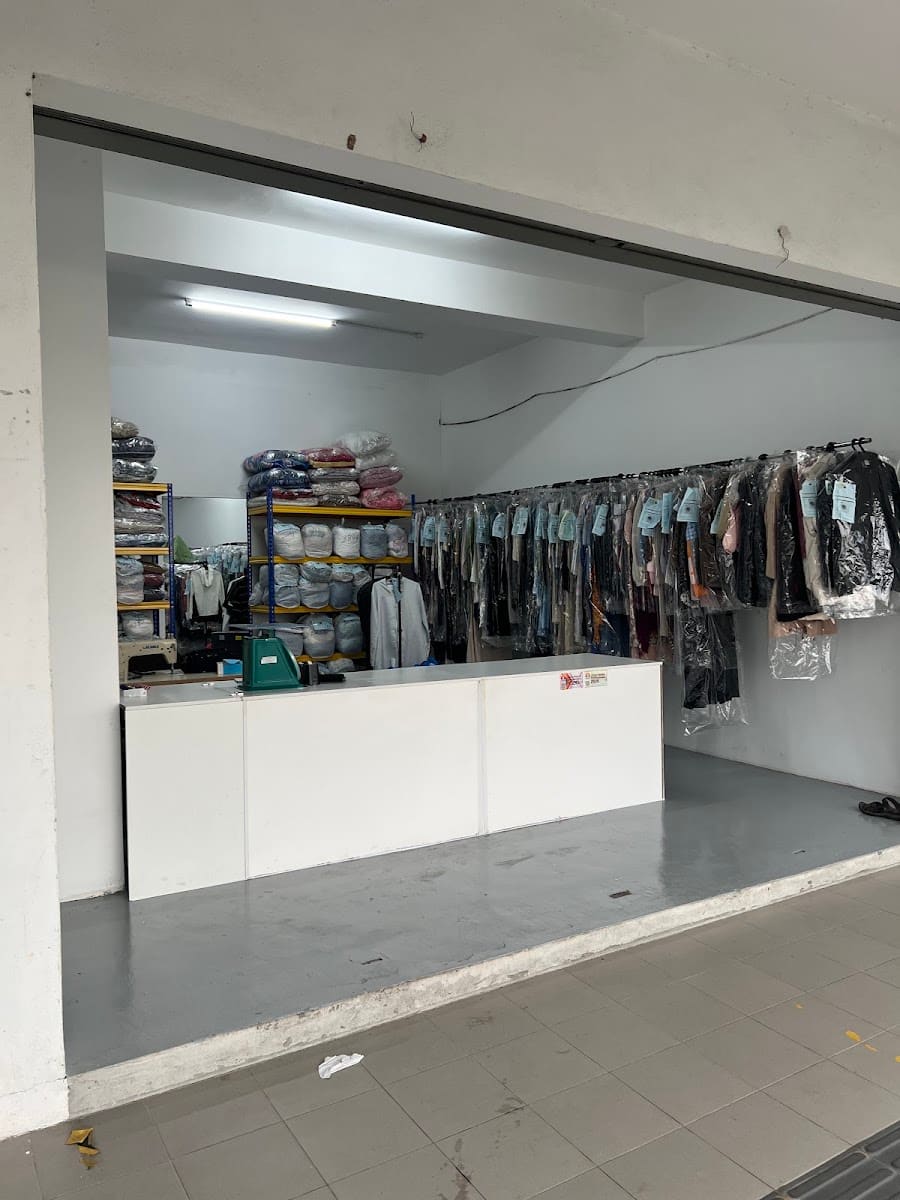 Shop interior with counter and hanging dry-cleaned garments